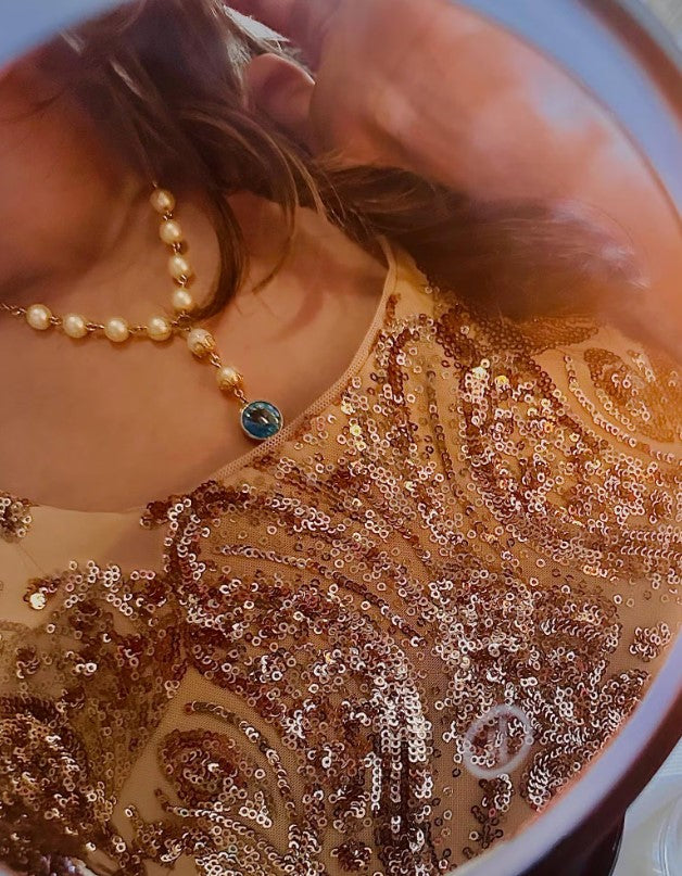 The Aria Stellata Necklace paired with a vintage-inspired outfit