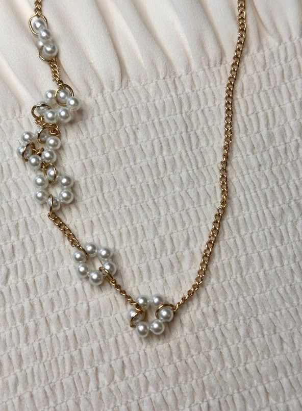 Close-up of the Luna Necklace on a fabric backdrop, emphasizing its elegant and sophisticated design.