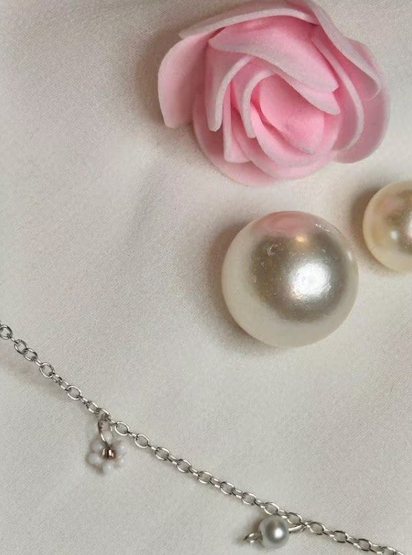 Teatime Necklace adorned with pearls and a single flower, emphasizing its vintage-inspired elegance.